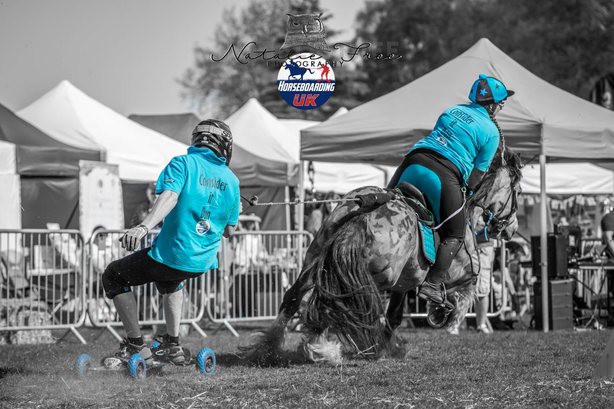 A person riding a horse board being pulled around a course by a horse and rider