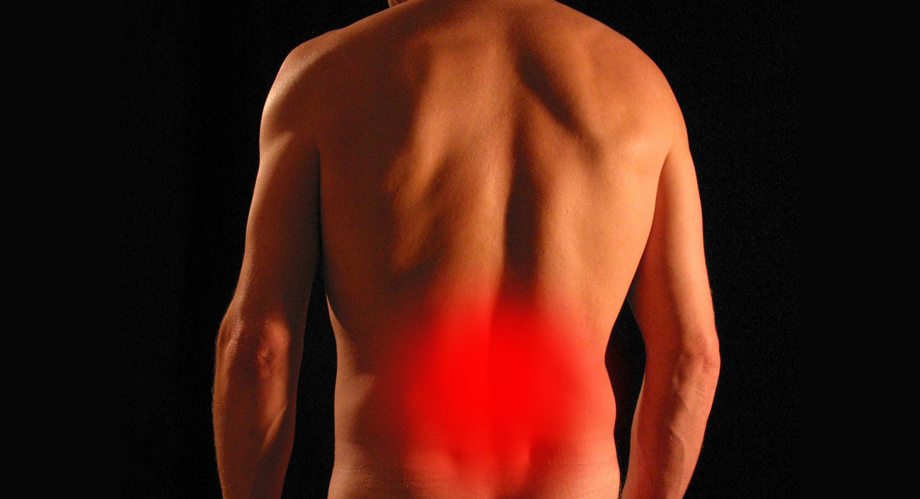 A picture of a persons back with a red area on their lower back