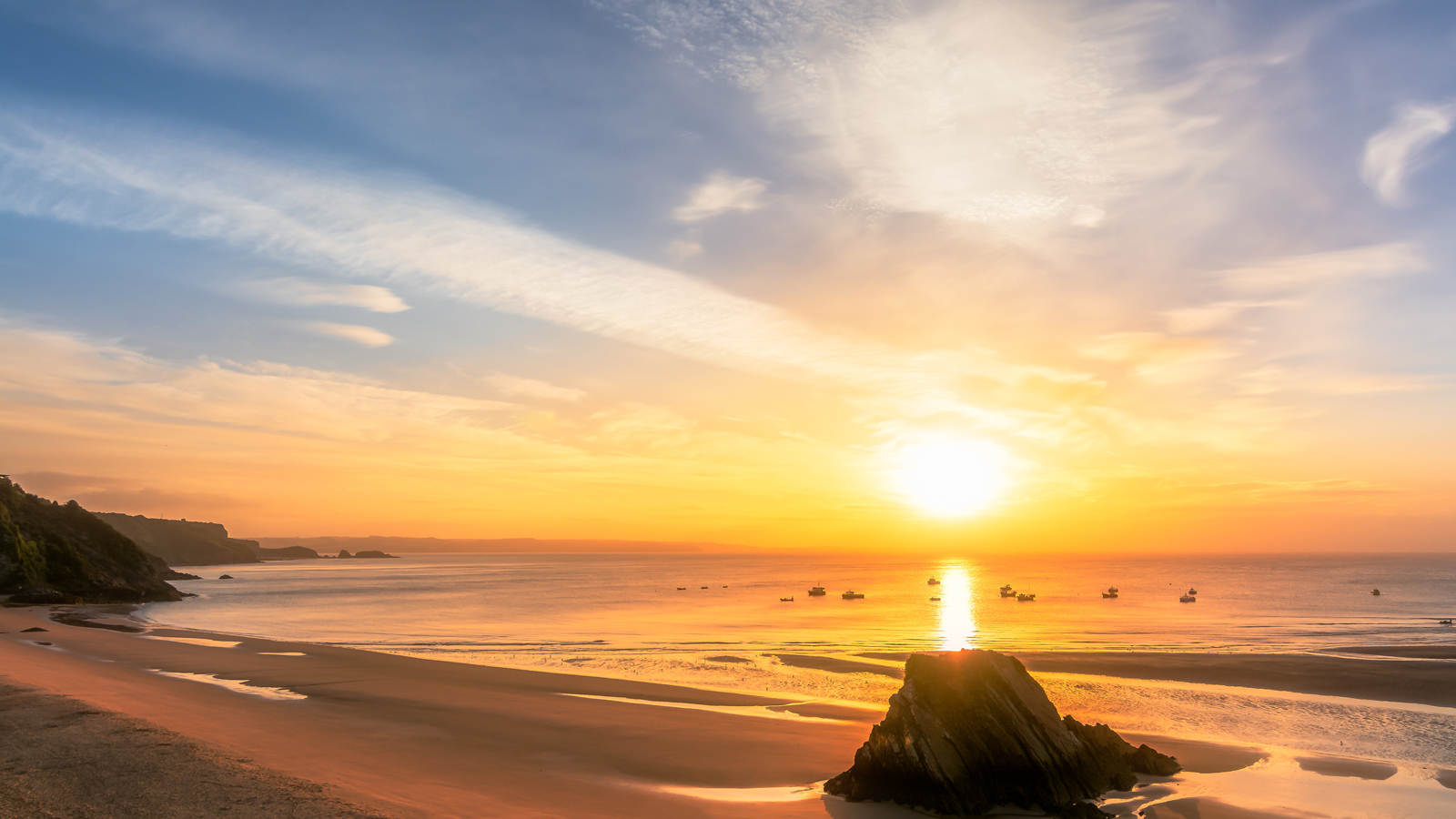 The sun setting over the Pembrokeshire sandy coastline